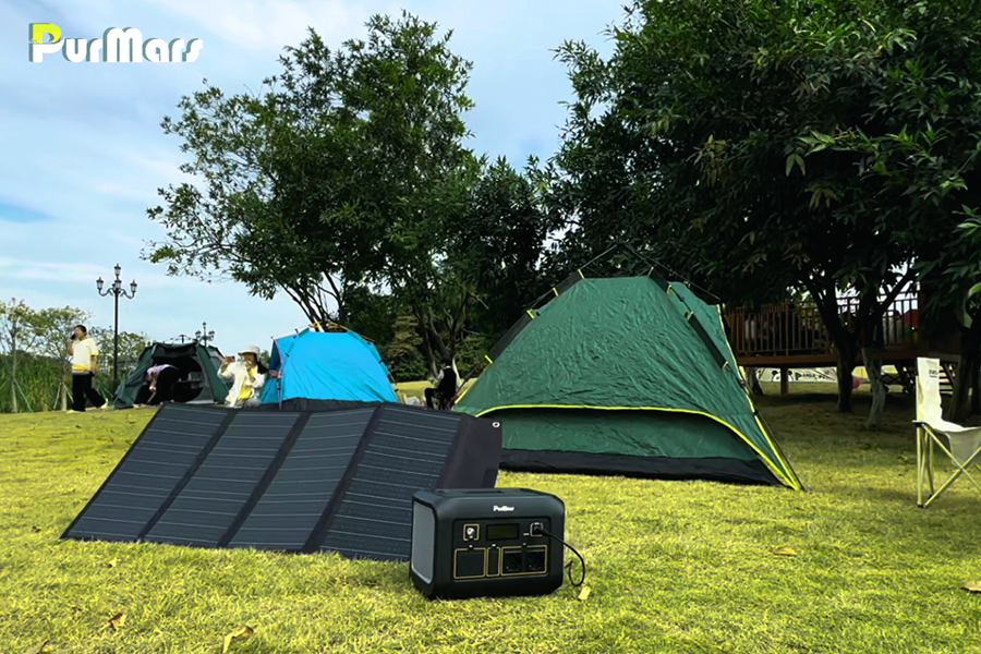 PurMars Portable Energy Storage Power Station with Solar Panel, Camping Scene with Tents, Grass, Trees, Ideal for Solar-Powered Outdoor Leisure and Emergency Power Supply